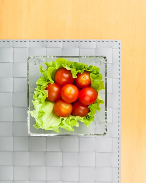 Légumes frais sur assiette, fond tapis gris — Photo