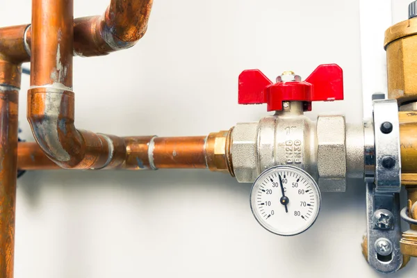 Temperature gauge indicator with water tap in boiler-room — Stock Photo, Image