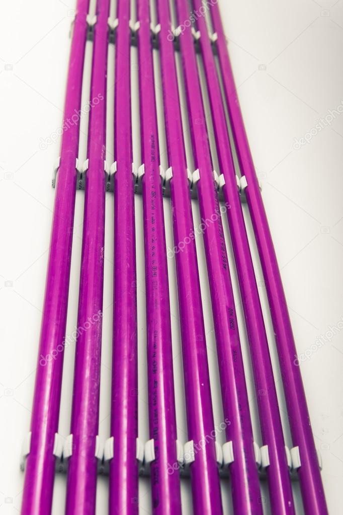 purple plastic pipes of underfloor heating system