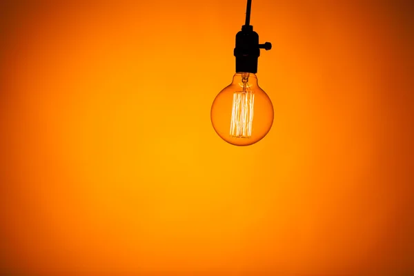 Bulb lamp with warm light background — Stock Photo, Image