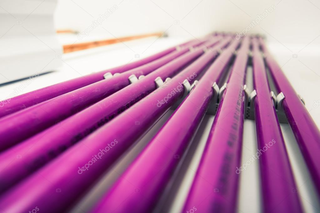 purple plastic pipes of underfloor heating system