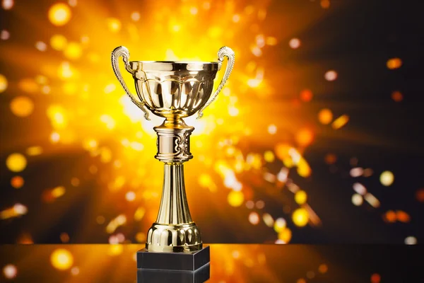 Gold cup trophy against shiny sparks background — Stock Photo, Image