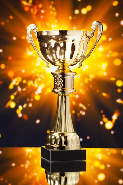 Gold cup trophy against shiny sparks background — Stock Photo, Image