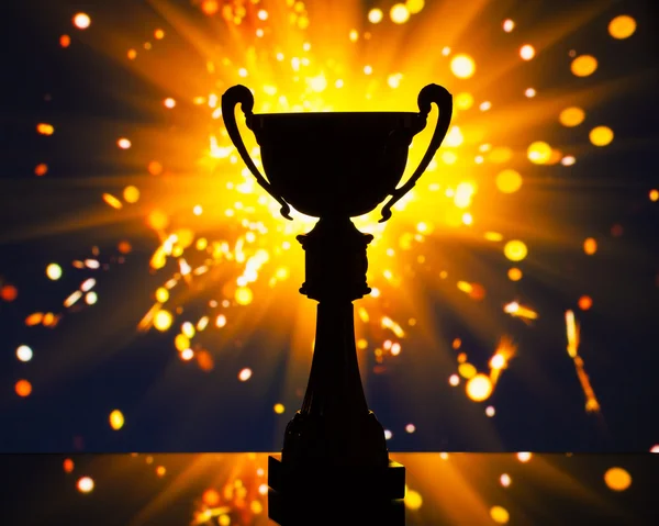 Cup trophy silhouette against shiny sparks background — Stock Photo, Image