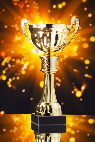 Gold cup trophy against shiny sparks background — Stock Photo, Image