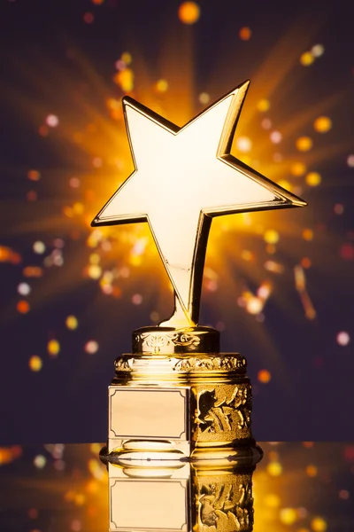 Gold star trophy against shiny sparks background — Stock Photo, Image