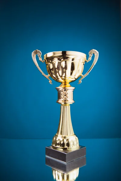 Gold cup trophy on blue background — Stock Photo, Image
