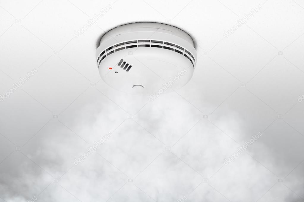 smoke detector of fire alarm in action, white background