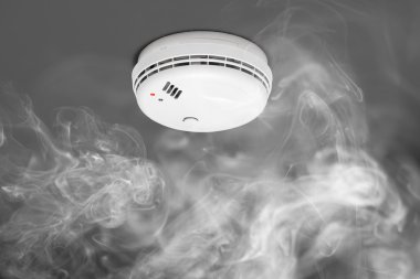 smoke detector of fire alarm in action clipart