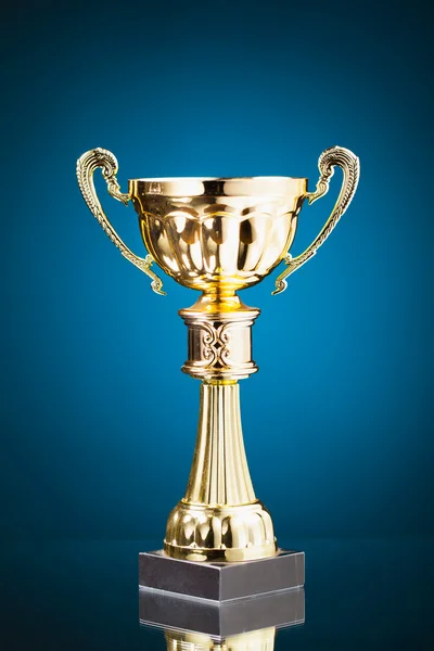 Gold cup trophy on blue background — Stock Photo, Image