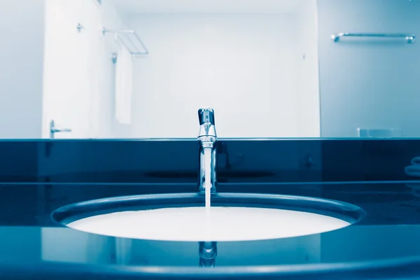 Faucet with flowing water, blue tone — Stock Photo, Image