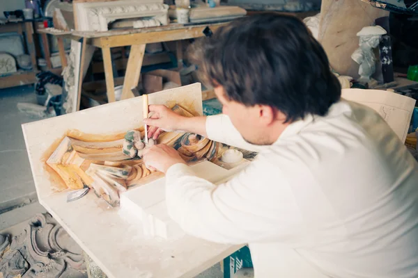 Restorer working with antique decor element — Stock Photo, Image