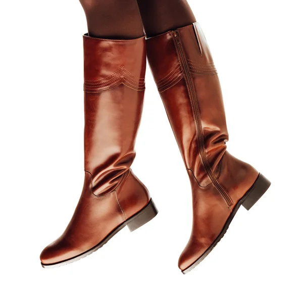 Woman legs wearing brown leather high boots — Stock Photo, Image