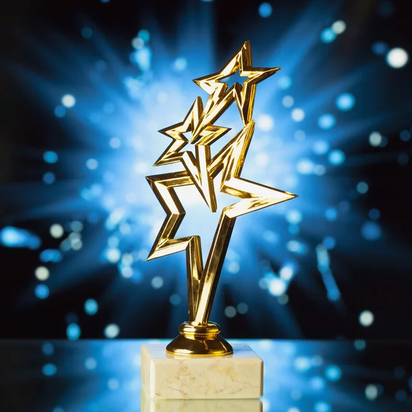 Gold stars trophy against shiny sparks background — Stock Photo, Image