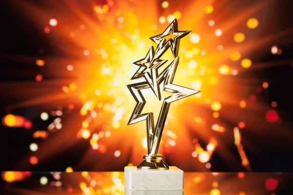 Gold stars trophy against shiny sparks background — Stock Photo, Image