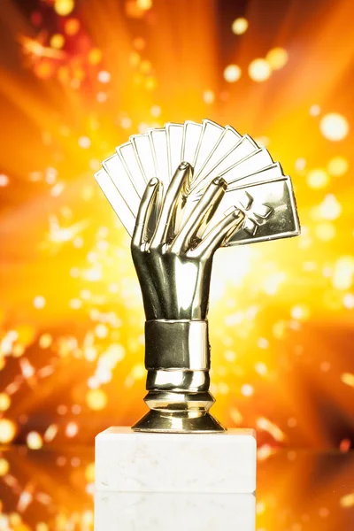 Poker cards trophy against shiny sparks background — Stock Photo, Image