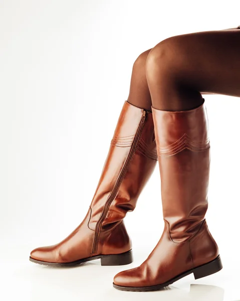 Woman legs wearing brown leather high boots — Stock Photo, Image