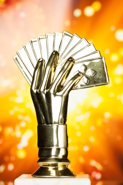 Poker cards trophy against shiny sparks background — Stock Photo, Image