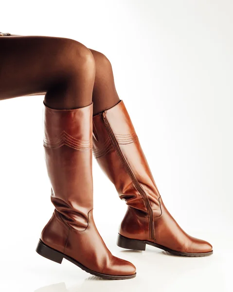 Woman legs wearing brown leather high boots — Stock Photo, Image