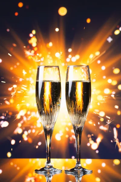 Champagne glass against sparkler background — Stock Photo, Image