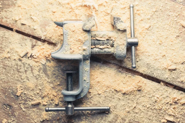 Vintage vice tool on wooden background — Stock Photo, Image