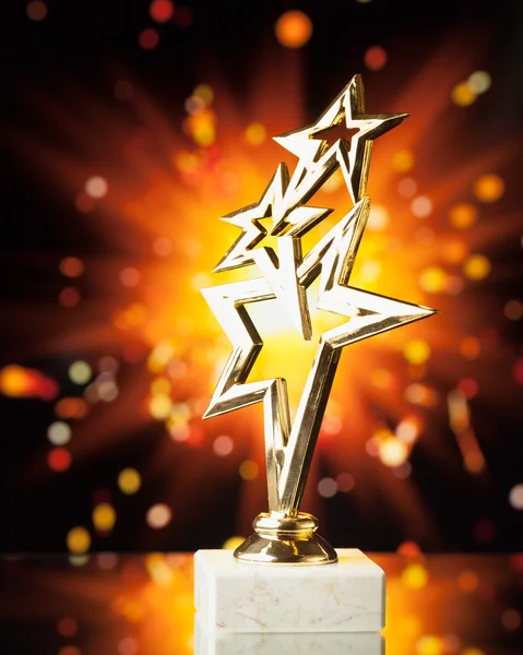 Gold stars trophy against shiny sparks background — Stock Photo, Image