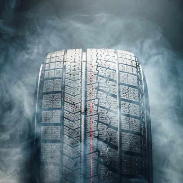 winter tire in smoke