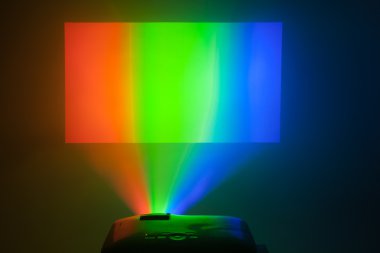 projector in action with illuminated rgb screen clipart