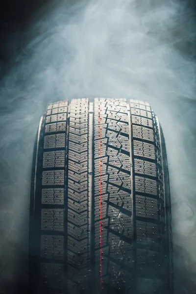 winter tire in smoke