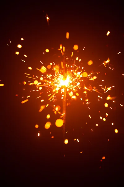 Christmas sparkler in haze with red light — Stock Photo, Image