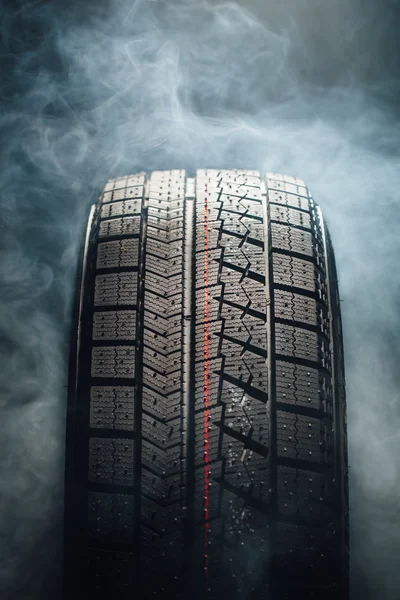 winter tire in smoke