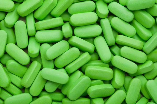 Doplňky stravy, zelené vitamin prášky — Stock fotografie