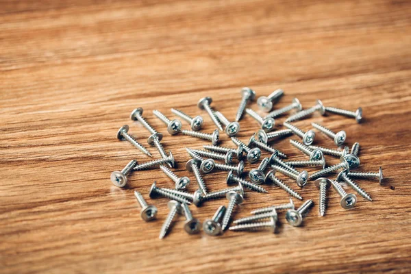 Screws fasteners hardware on wooden background — Stock Photo, Image