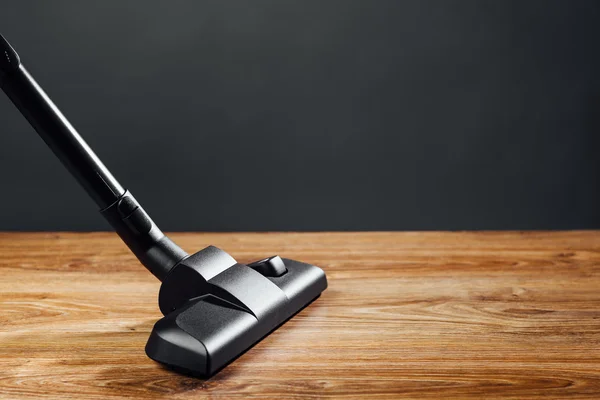 Vacuum cleaner brush on wooden floor — Stock Photo, Image