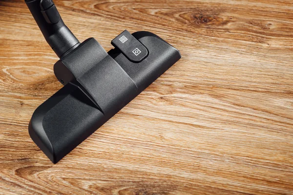 Vacuum cleaner brush on wooden floor — Stock Photo, Image