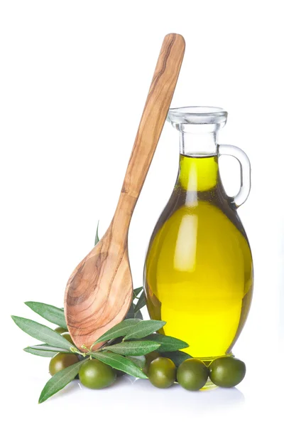 Olive oil bottle and wooden spoon isolated — Stock Photo, Image