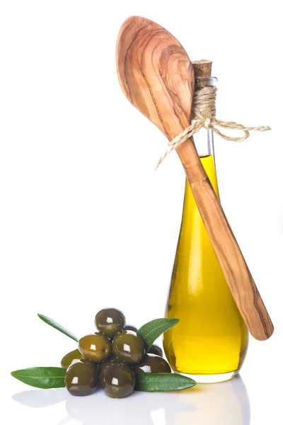 Olive oil bottle and wooden spoon isolated — Stock Photo, Image