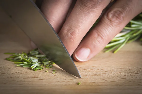 Chef chopping a rosemary branch — Stock Photo, Image