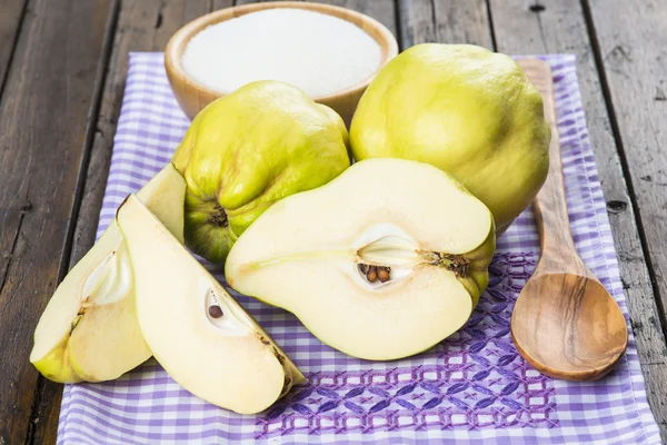 Quinces and sugar on the kitchen table — Stock Photo, Image