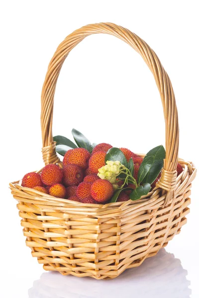 Basket with arbutus unedo fruits over white — Stock Photo, Image