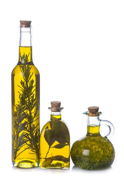 Olive oil bottles with aromatic herbs — Stock Photo, Image