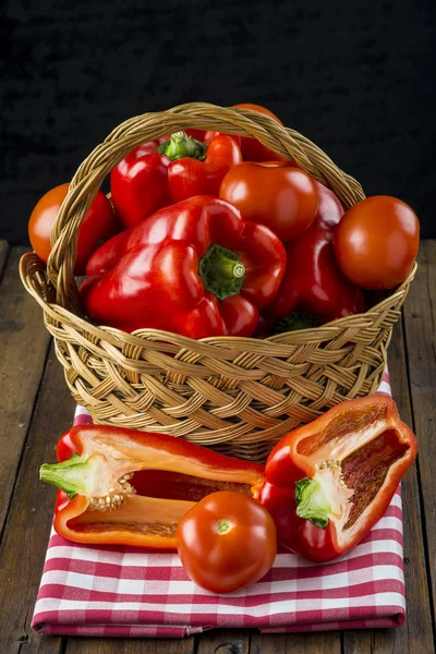 Basket with red peppers on the table of the kitchen — Stock Photo, Image