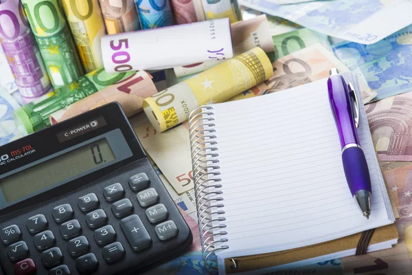 Calculator pen and notebook on the money — Stock Photo, Image