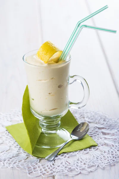 Banana smoothie decorated with a lemon zest — Stock Photo, Image