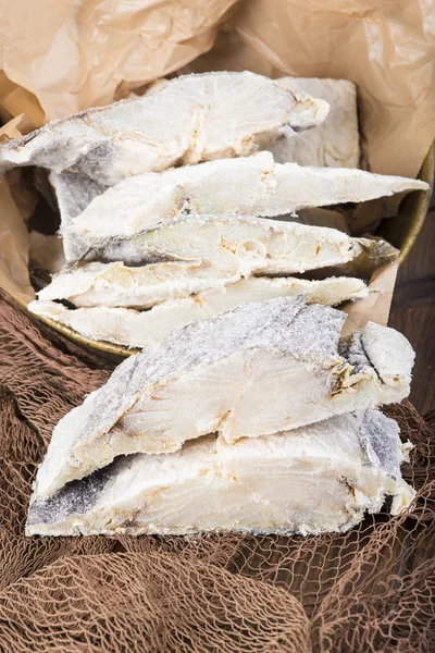 Uncooked salted cod on fishing nets — Stock Photo, Image