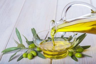 Bakire ekstra zeytin yağı bir kapta dökülen şişe