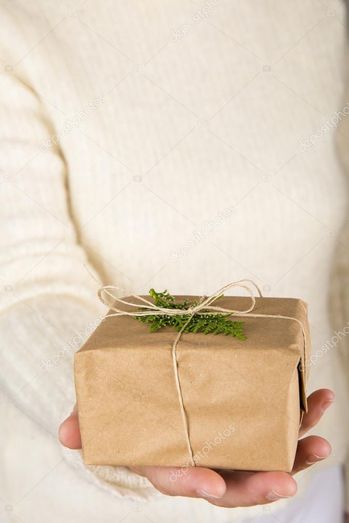 Woman hands holding a gift box