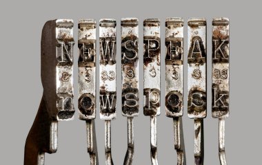 vintage old typewriter hammers  with the word  newspeak clipart