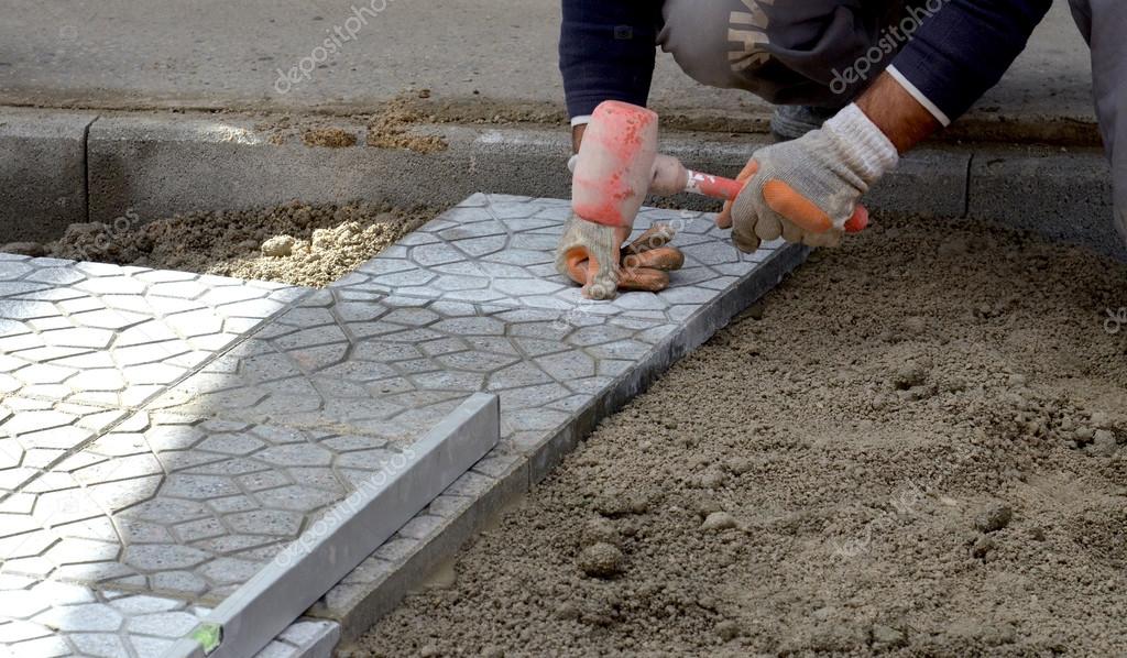 depositphotos_100788122-stock-photo-workers-paving-walkway.jpg