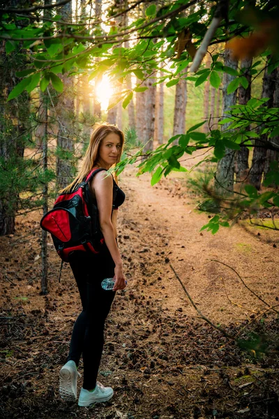 Young sexy girl with backpack in nature — Stock Photo, Image